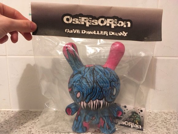 Cave Dweller figure by Osirisorion, produced by Self Produced. Packaging.