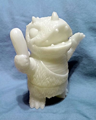 Caveman Dinosaur - Unpainted Glow figure by Josh Herbolsheimer, produced by Super7. Front view.