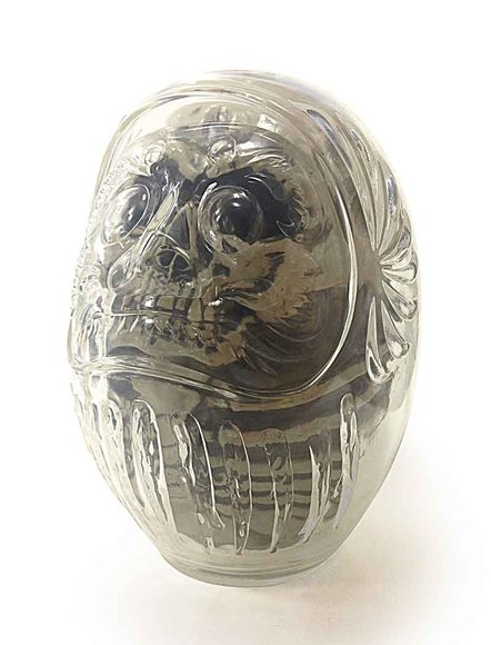 DARUMA SKULL - CLEAR w/ SMOKE GRAY FOSSIL figure by Kazzrock, produced by Secret Base. Side view.