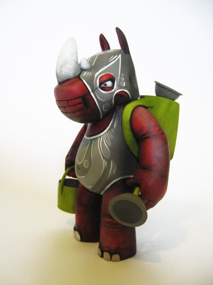 Red Lucha Rumpus figure by Scribe, produced by Cardboard Spaceship. Side view.