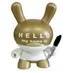 Hello My Name Is (HMNI) Gold figure by Huck Gee, produced by Kidrobot. Front view.