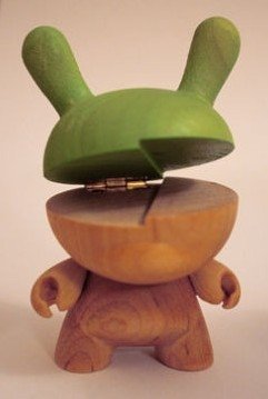 Exclusive wooden Dunny variant figure by Travis Cain, produced by Kidrobot. Front view.