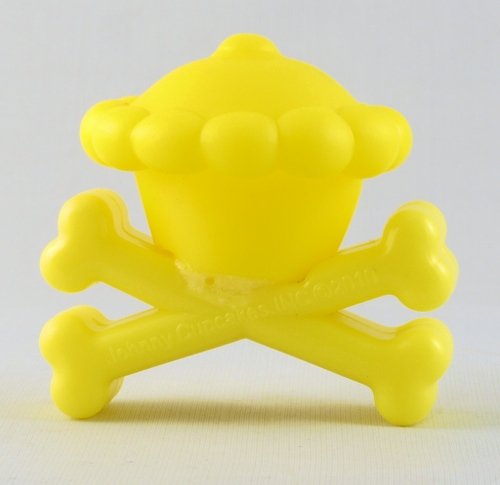 Crossbones Toy Banana figure by Johnny Cupcakes, produced by Johnny Cupcakes. Front view.