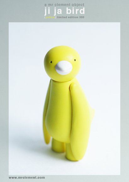 Yellow Ji Ja Bird figure by Mr. Clement. Front view.